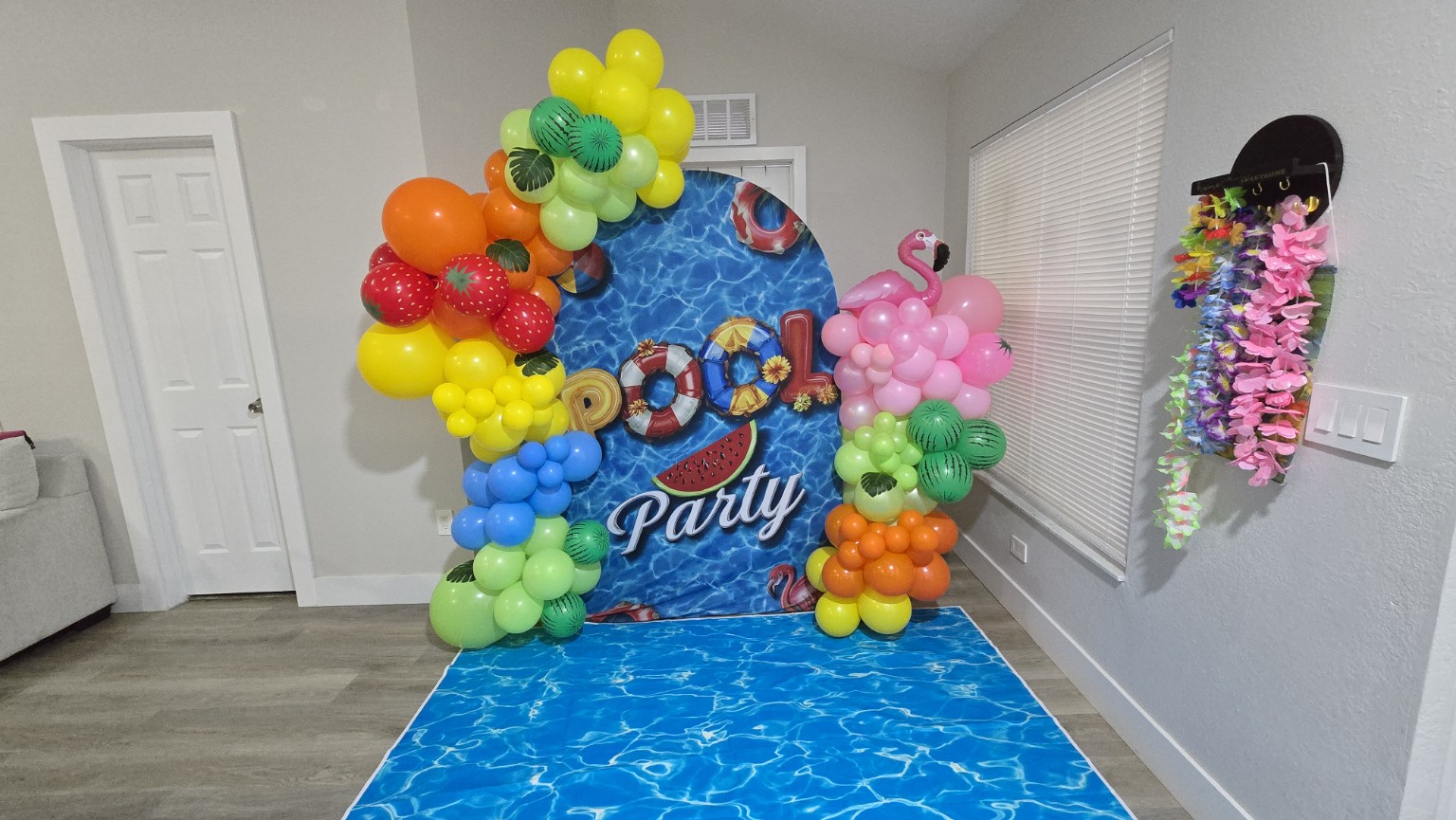 Colorful tropical pool party balloon decoration with fruit and flamingo accents by AABallons